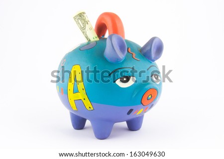 Money saving in a colorful piggy bank isolated on white background