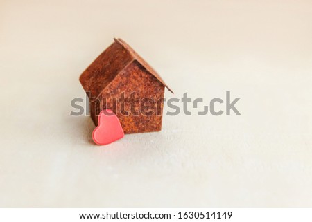 Miniature toy model house with red heart on wooden backdrop. Eco Village, abstract environmental background. Real estate mortgage property insurance sweet dream home ecology concept