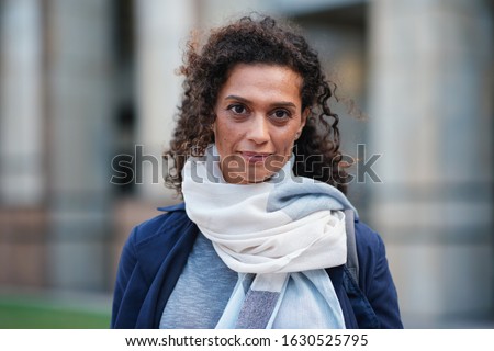 Portrait beautiful mature woman smiling confident independent female in city Royalty-Free Stock Photo #1630525795