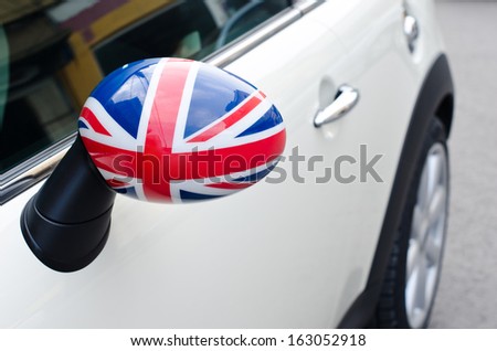 Close up on a side mirror of a car with the UK flag on it. Patriotic driver. England flag.