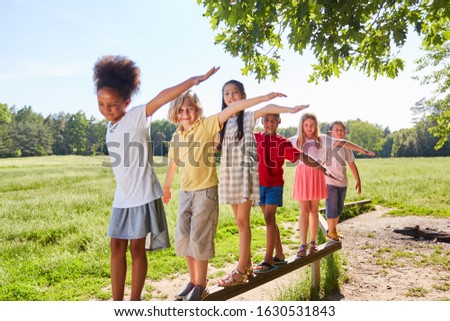 Group of kids while balancing on a beam for skill Royalty-Free Stock Photo #1630531843