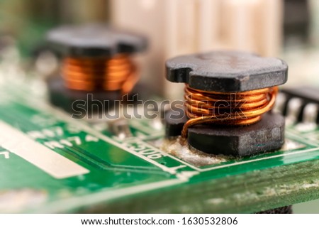 Ferrite core inductors on an LCD TV motherboard  Royalty-Free Stock Photo #1630532806