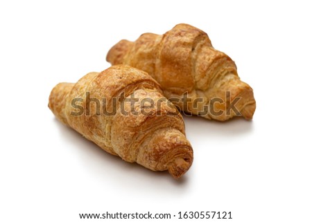 Two mini croissants puff pastry, filled with buttercream isolated on a white background. Traditional French Breakfast