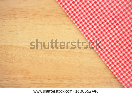 Classic pink plaid fabric or tablecloth on wood desk with copy space