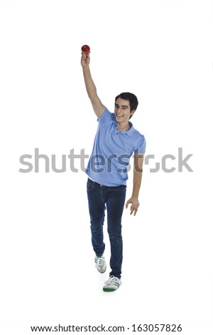 Portrait of a happy man bowling a cricket ball
