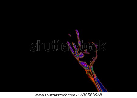 hand showing gesture in the dark black background