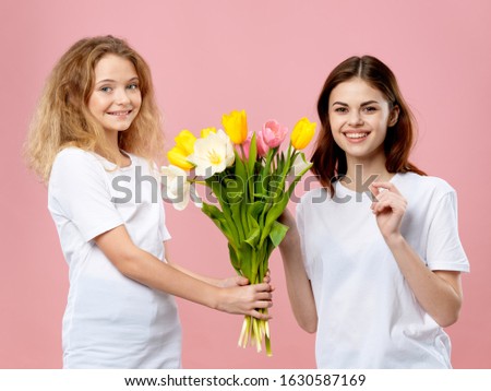 Mom and daughter with a bouquet of flowers holiday fun Studio