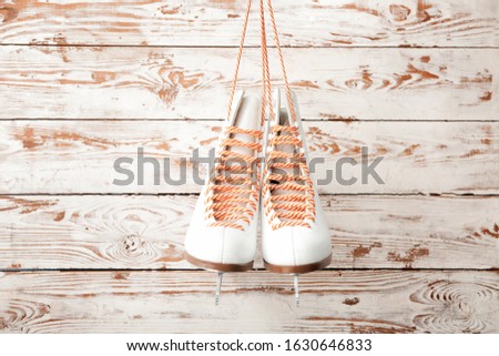 Ice skate shoes on white wooden background