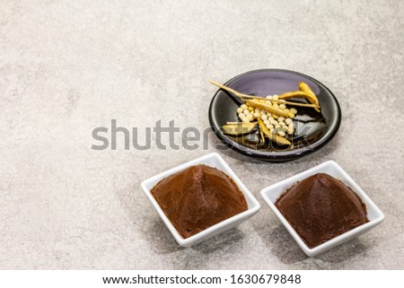 Miso paste, traditional Japanese seasoning. Two types, dark and light brown with dry soya beans. Stone concrete background, copy space