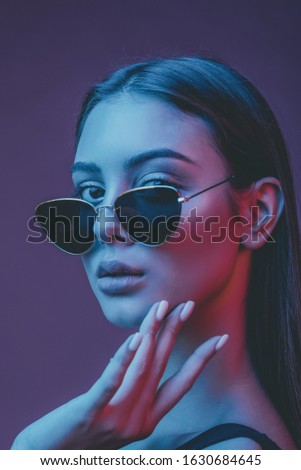 beautiful girl. Gorgeous brunette with plump natural lips. Portrait of a girl in the studio with color filters. Portrait, fashion, beauty, glow. Perfect profile of an interesting woman. Photo tinted