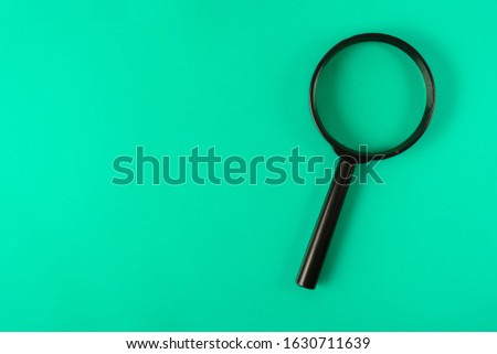 magnifying glass on a green leaf