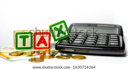 Tax Time concept - Calculator and paper money on white background. Shallow depth of field,. Soft focus