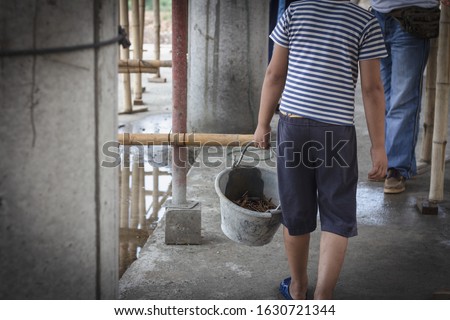 The concept of illegal child labor, Children are forced to work construction. Children violence and trafficking,   Rights Day on December 10 Royalty-Free Stock Photo #1630721344