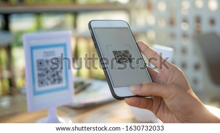 Using mobile phones to pay scanning promotional discounts in restaurants.