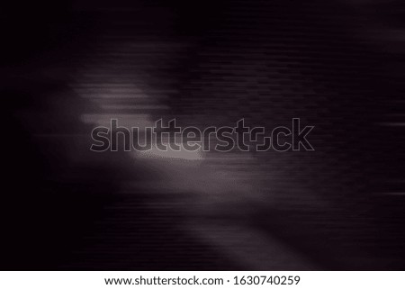 Abstract lines on a black background blur in motion