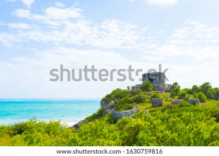 Ruins of ancient Tulum. Architecture of ancient maya. View with sea. Blue sky and lush greenery of nature. travel photo.  Yucatan. Mexico.