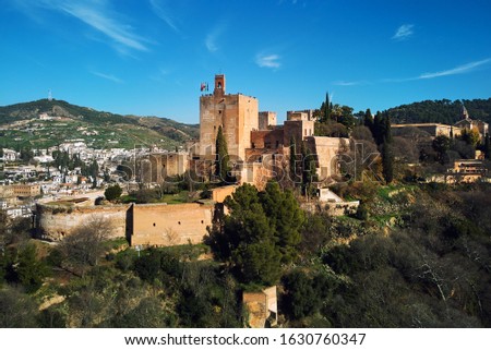 Aerial beautiful drone point of view Granada castle surrounding lands and cityscape, Alhambra or Red Castle, located on top of hill al-Sabika. Moorish palace fortress complex in Andalusia, Spain