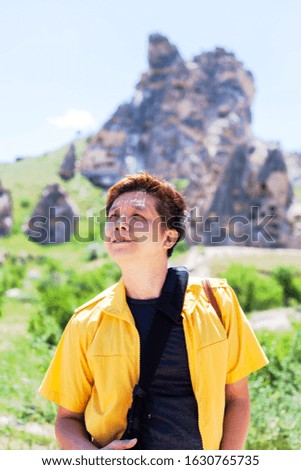Vacation in Turkey view of Uchisar Castle Village during summer with male Chinese tourist model