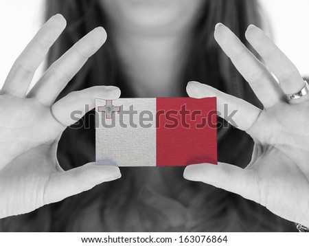 Woman showing a business card, flag of Malta