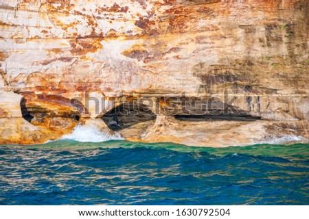 This beautiful bright vibrant nature picture of crashing waves was taken on a boat cruise from Munising City Dock of the Pictured Rocks National Lakeshore located in the Upper Peninsula, Michigan