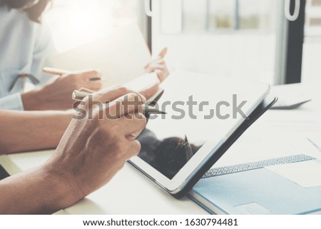 Businessman and partner hand using digital tablet and making presentation business strategy.

