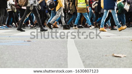 Legs of a crowd of busy pedestrians crossing a street in Vienna Royalty-Free Stock Photo #1630807123