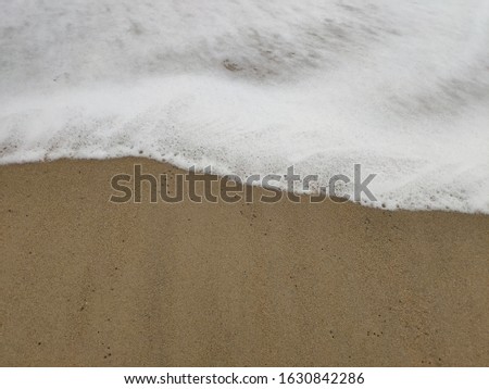 Pictures of sea bubbles from the waves hitting the sand