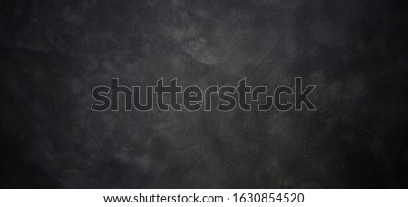Black background of abstract concrete wall with more dark tone at boundary.