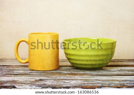 yellow cup on wooden table