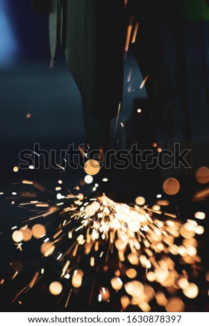 Industry electric fiber cutting steel with beautiful flash of sparks, Building construction concept. close up
