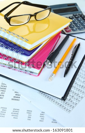 Office supplies with glasses and documents close up