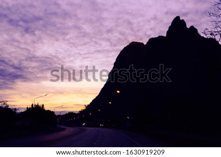 Asphalt road  at sunrise.  mountains. toning effect