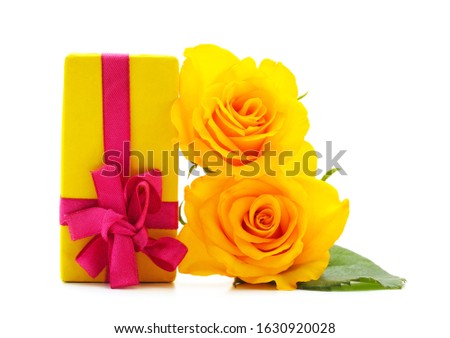Yellow rose with a gift isolated on a white background.