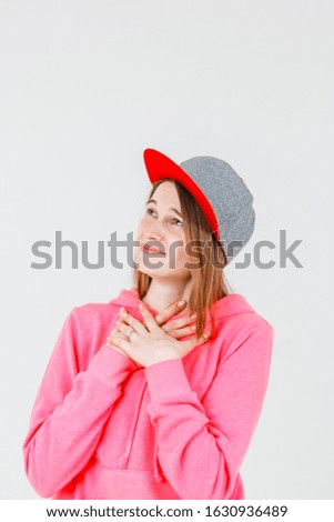 young beautiful woman in a cap on a white background