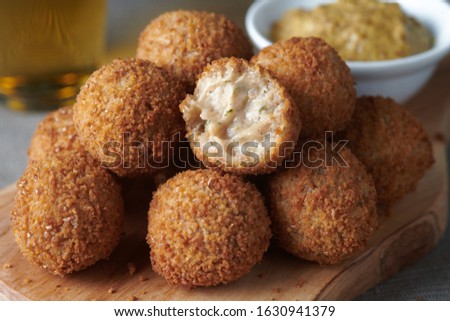 Bitterballen are a Dutch meat-based snack, made by making a very thick stew thickened with roux and beef stock and generously loaded with meat. Royalty-Free Stock Photo #1630941379
