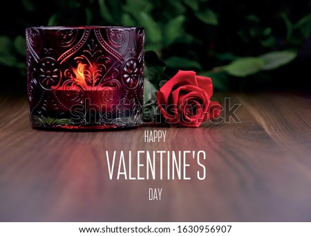 Happy Valentine's Day greeting card with red rose and candle. Red rose with candle on a wooden background stock images. Romantic still life with red rose and candle cup holder. Valentine's Day concept