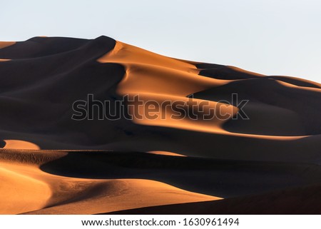 the formation of sand dunes in dasht e lut desert at sunset and shadows