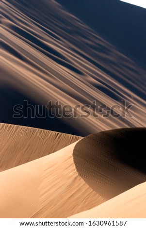 the formation of great sand dunes in dasht e lut desert with sand textures in foreground