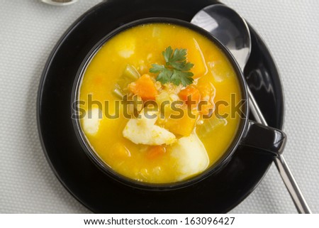 Delicious warming hearty vegetable soup with a parsley garnish.