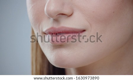 Close up young woman mouth smiling happy beautiful soft lips showing healthy teeth dental lead by hand on the face attractive female happy health cosmetics young slow motion