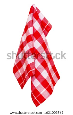 Towels isolated. Closeup of a red and white checkered napkin or tablecloth texture isolated on white background. Kitchen accessories. Macro photograph.