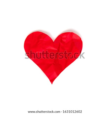 Red crumpled paper heart isolated on white background. Theme of divorce and unrequited love concept. Stock photo