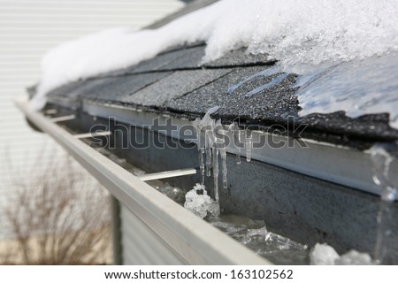 Ice on roof and gutters Royalty-Free Stock Photo #163102562
