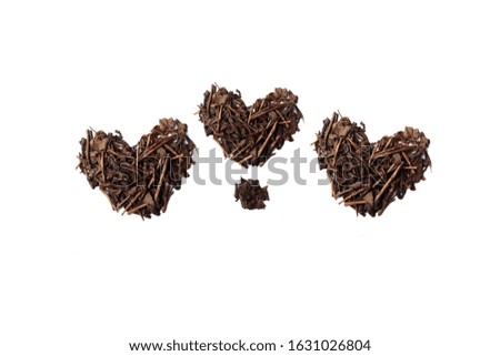 Heart shapes for valentine's day made with dried tea leaves placed on white background from the top view has space for your messages