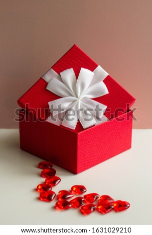 open red gift box with a white bow. Gift concept with love. Valentine's Day gift, wedding gift.