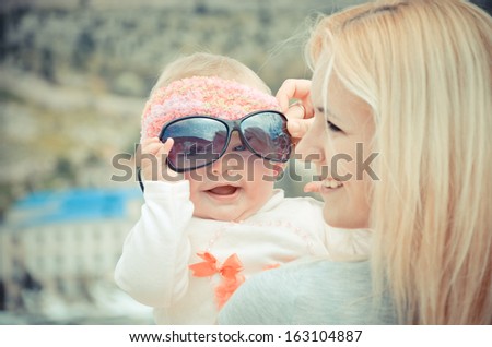 Portrait of young woman with daughter outdoors Royalty-Free Stock Photo #163104887