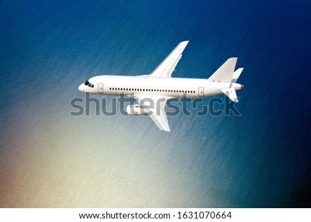 Passenger plane in flight. A plane makes a transatlantic flight over the ocean. Royalty-Free Stock Photo #1631070664