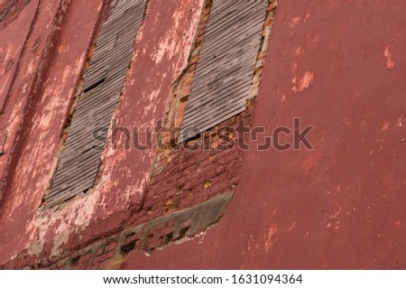 An old dirty red wall with painted bricks under the sunlight - a cool picture for a 
background