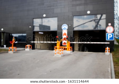 Sign of Entrance to the underground parking. View of new modern apartment house. Residential complex in Europe. Blurred.


