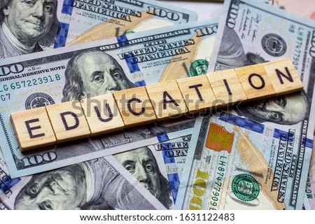 The word education on dollar usa background. College credits, graduation funds, tuition money concept Royalty-Free Stock Photo #1631122483